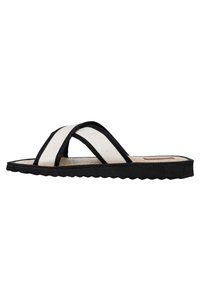 Black and white flip-flop with two crossing straps. The straps feature a textured fabric, and the sole has a scalloped edge.
