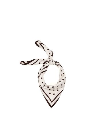 Bela svilena ruta s črnimi pikami in črtami, zavezana v ohlapno vozliček.