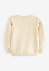 Sweatshirt beige avec manches bouffantes et nœuds décoratifs sur les épaules. Tissu lisse avec des poignets et un ourlet côtelés. Encolure ronde simple.