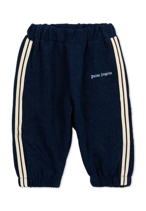 Pantalones deportivos azul marino con cintura y puños elásticos, rayas blancas en los laterales y texto "Palm Angels" en el muslo izquierdo.