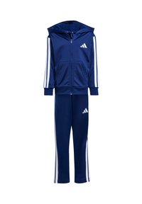 Sada tepláků v námořnické modři vyrobená z měkké tkaniny; obsahuje zipovou mikinu s dvěma předními kapsami a bílými postranními pruhy na rukávech a kalhotách.