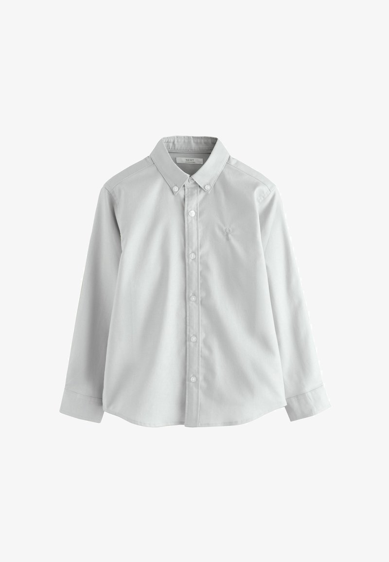 Gai pelēkās krāsas krekls ar garām piedurknēm, pogājams ar nospiestu apkakli un smalku izšūtu logotipu kreisajā krūtī.