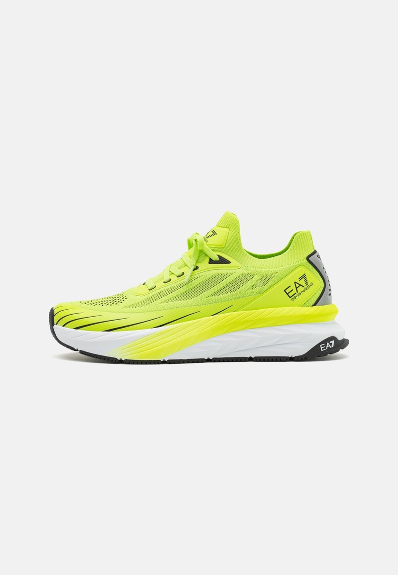 Neon yellow athletic shoes with a textured mesh upper, black sole, and white midsole. Features a cushioned design and reinforced accents.