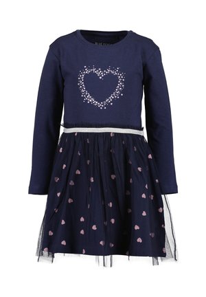 Marineblaue Langarmkleid mit silbernem Herz aus kleinen Sternen oben und einem Rock mit rosa Herzmustern und einem transparenten Überzug.