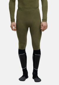 Collants de base ajustés verts avec des détails texturés. Chaussettes noires montantes avec des accents et des panneaux gris. Tissu doux et extensible.
