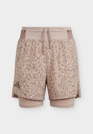 Heledatpruunid sportlikud lühikesed püksid leopardimustrilise pealiskihi ja sisemise kompressioonikihiga, nööriga vöökohaga ja Adidas logo vasakul jalal.