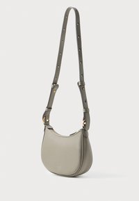 Kožená taška cez plece v tlmenej olivovo zelenej farbe, zakrivená silueta, nastaviteľný popruh s dierkami, zlaté kovanie, hladký povrch.