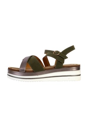Green and brown leather sandal with cross-strap design, adjustable strap, brown insole, and white textured wedge sole with black accents.