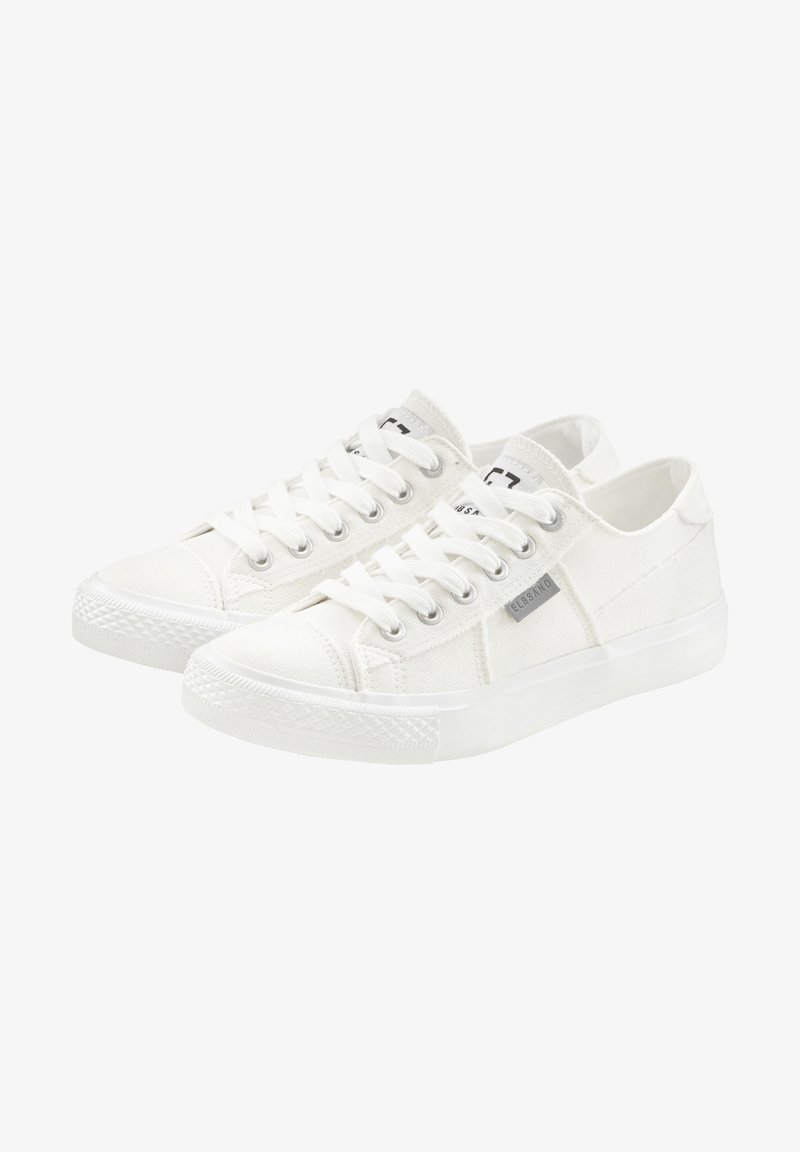 White canvas sneakers with a low top, featuring round laces, a textured rubber sole, and a small gray logo on the side.