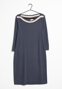 Šedé šaty s dlouhým rukávem a kulatým výstřihem, vyrobené z texturované látky, s béžovým proužkem přes ramena. Věší se na černém háčku.