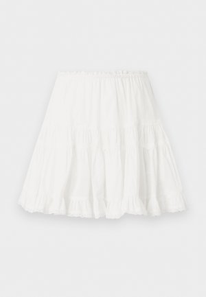 Jupe blanche à volants avec taille élastique et ourlet volanté, fabriquée en tissu léger.