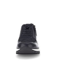 Scarpa sportiva nera con una combinazione di materiali in rete e pelle, design con lacci, dettaglio con zip frontale e suola in gomma testurizzata.