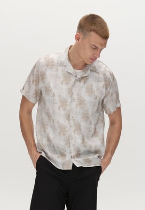 Short-sleeve button-up shirt in light beige fabric with a subtle floral print, featuring a camp collar and relaxed fit.
