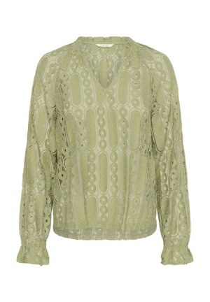 Blusa verde clara con escote en V, mangas largas y delicados detalles de encaje con patrones circulares y puños con borde festoneado.