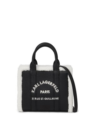 Czarna skórzana torebka z białą lamówką z owczej skóry, podwójnymi uchwytami oraz napisem z przodu: Karl Lagerfeld Paris 21 Rue St-Guillaume.