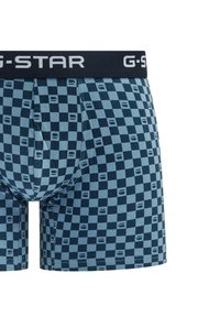 Marineblauwe en lichtblauwe geruite boxershorts met een elastische tailleband met G-STAR-logo en een zachte katoenmix. Heeft een aansluitende pasvorm en subtiele patronen.
