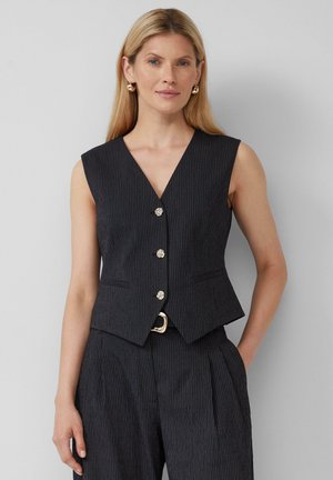 Zwarte pinstripe mouwloze vest met een V-hals, voorzakken en vijf decoratieve knopen. Textuurstof met een getailleerde pasvorm.