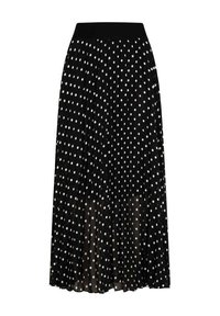 Jupe plissée noire à pois blancs, avec une large ceinture élastique et une couche transparente pour plus de texture et de mouvement.