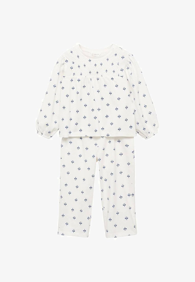 Ensemble de pyjama en coton blanc comprenant un haut à manches longues avec des poignets élastiques et un imprimé floral, associé à un pantalon assorti, également orné de fleurs.
