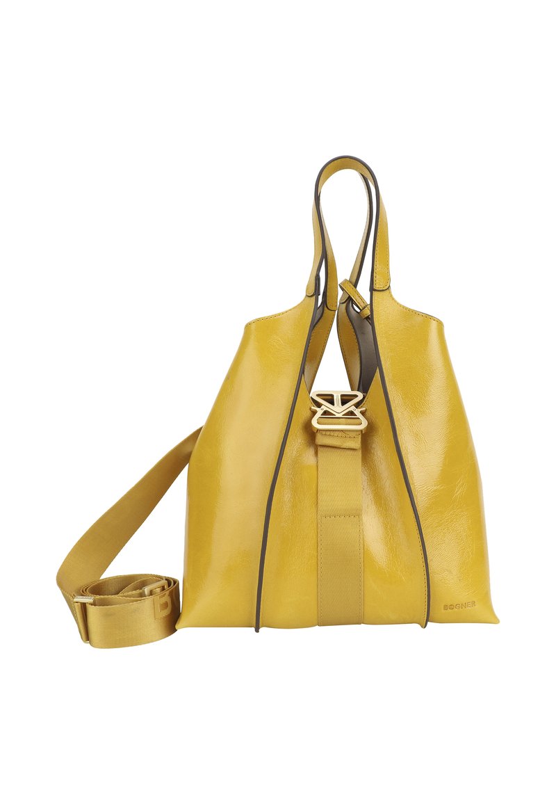 Żółta skórzana torebka o strukturalnym kształcie, z podwójnymi uchwytami, odczepianym paskiem i kontrastowym ciemnym wykończeniem. Zawiera wyraźny akcent logo.