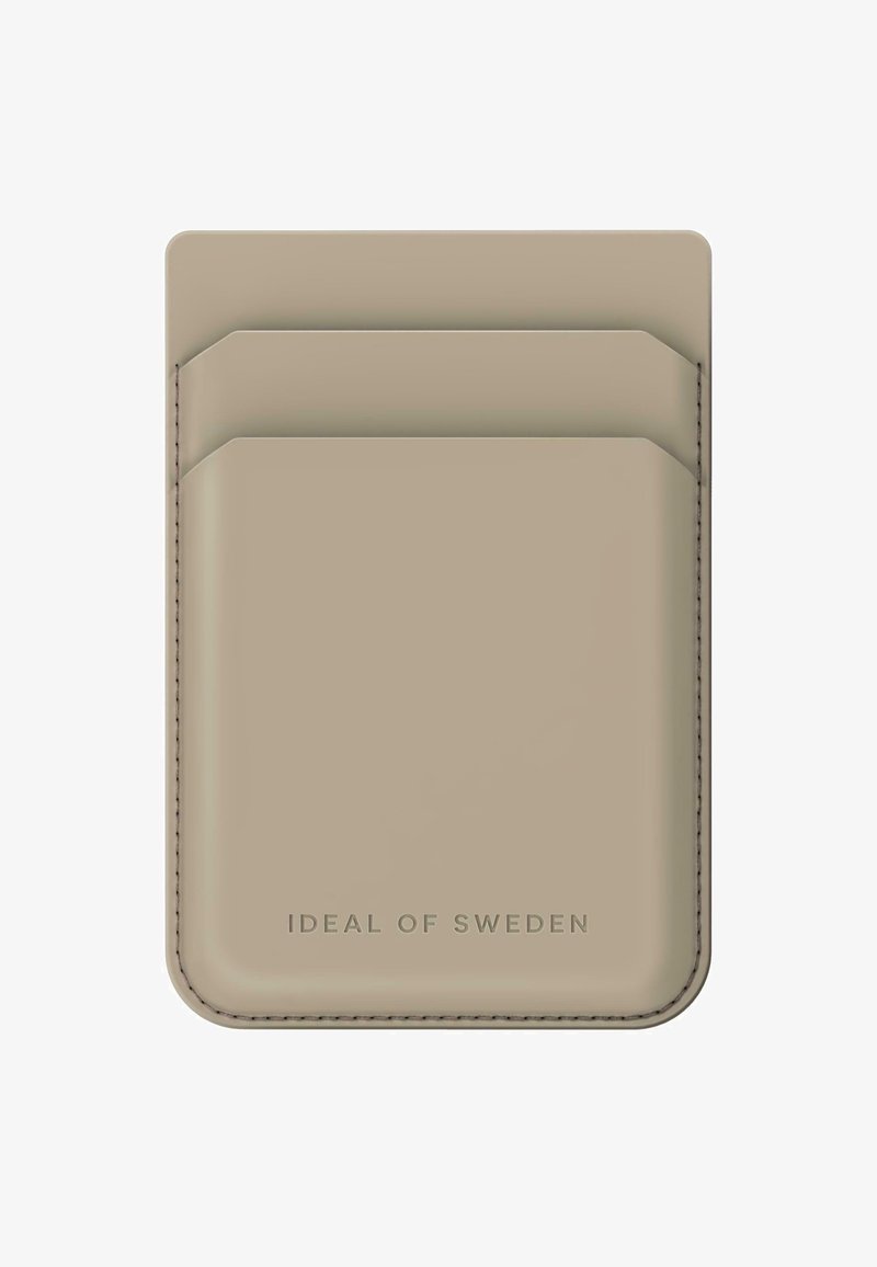 Cardholder bej din piele, cu două sloturi pentru carduri în partea de sus și cusături subtile. Dispune de logo embossat în partea de jos.