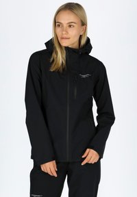 Black waterproof jacket with a fitted design, hood, zippered front, and logo detail on the chest. Smooth texture, suitable for outdoor use.
