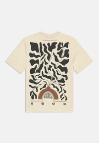 Beige T-shirt with black abstract plant design, "REBEL" text under an arch, "GROW INTO THE WILD" and "NO REGRETS SINCE 2013" in red lettering.