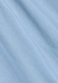 Tissu bleu clair avec une texture lisse, présentant un motif de tissage diagonal subtil. Pas de matériel ou d'accents visibles.
