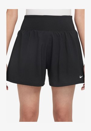 Pantaloni sportivi neri con una vita ampia e texturizzata, fit largo e tessuto morbido. Presentano un piccolo logo bianco Nike sull'orlo inferiore.