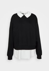 Felpa nera con maniche lunghe, design cropped e colletto bianco. Strato bianco visibile sul fondo, con polsini e orlo a costine.