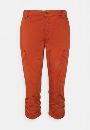 Pantalones cargo cortos de color naranja óxido con cintura con botones, bolsillos laterales y dobladillos fruncidos sobre un fondo claro liso.