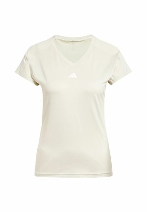 Šviesiai smėlio spalvos V-kaklu sportinė marškinė, trumpomis rankovėmis, su baltu Adidas logotipu ant krūtinės ir tekstūruota detale aplink kaklą.