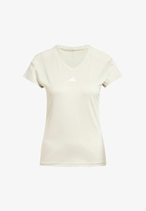 V-paita urheilupaita vaaleassa beige-kankaassa, lyhyt hiha, valkoinen Adidas-logo rinnassa ja teksturoitu yksityiskohta kauluksen ympärillä.