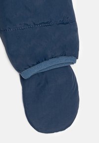 Mitten isolé bleu marine avec une texture douce et lisse. Présente un design à revers et des coutures élastiques pour un ajustement sécurisé.