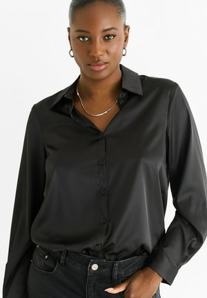 Black, long-sleeve button-up shirt in a smooth fabric. Features a classic collar, front buttons, and a relaxed fit with cuffs.