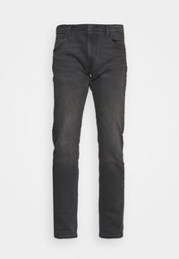 Jeans de mezclilla negra con un corte ajustado, cinco bolsillos, pasadores para cinturón y un desgaste sutil. La tela tiene una textura suave con un diseño clásico.