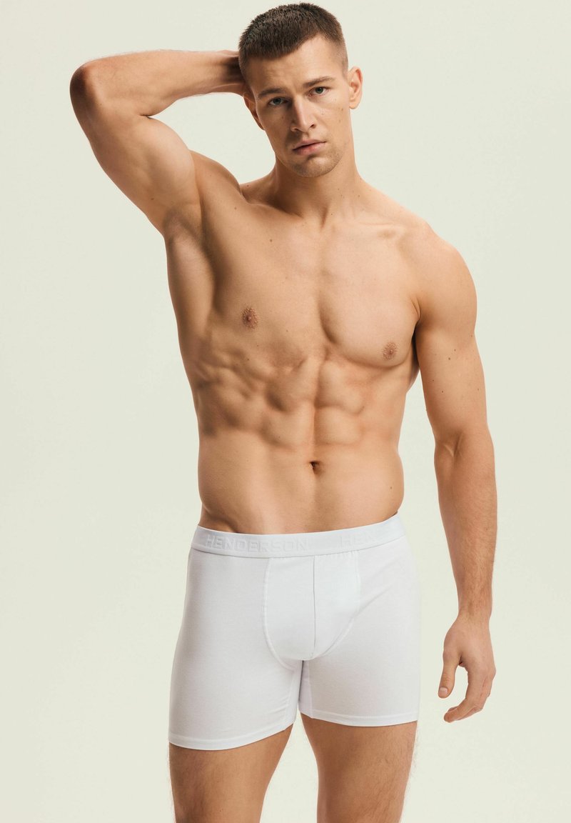 Białe bokserki męskie z wygodnym elastycznym paskiem w talii z wytłoczonym logo. Gładki bawełniany materiał i dopasowany krój.