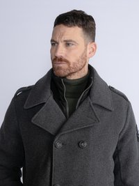 Dark grey wool coat with large lapels, double-breasted closure, and two buttons. Layered over a black textured inner jacket.