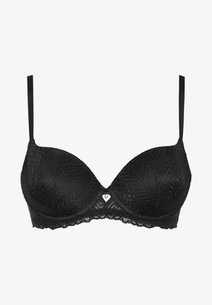 Soutien-gorge en dentelle noire avec un motif zigzag texturé, des bonnets moulés lisses, des bretelles ajustables et un accent décoratif en forme de cœur au centre.