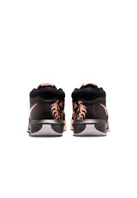 Black athletic shoes with pink accents, featuring a mesh upper, padded collar, and lion graphic design on the heel, with a rubber sole.