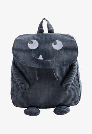 Donkergrijze corduroy kinderrugzak in de vorm van een glimlachend monster met grote ogen, kleine armen en voeten.