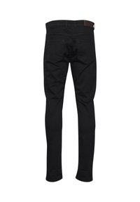 Jeans negros ajustados de corte Slim, con una textura suave, que cuentan con dos bolsillos traseros y una cintura simple con una etiqueta de marca.