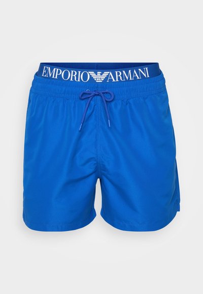 Shorts de bain bleus en matériau léger, dotés d'une taille élastique avec cordon de serrage et d'un logo imprimé sur la ceinture.