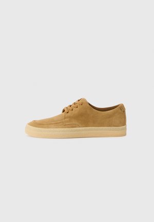 Suede tan sneakers with a rounded toe, lace-up front, and rubber sole. Features stitching accents and a low-profile design.