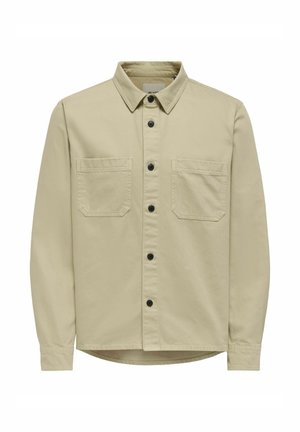 Beige Hemd aus Baumwolle mit Knopfleiste. Verfügt über einen Hemdkragen, zwei Brusttaschen und schwarze Knöpfe. Glatte Textur mit geradem Saum.