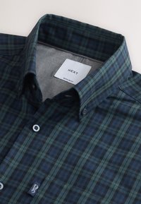 Buttoned dark green and navy checkered shirt with a button-down collar and a white label reading Next Regular Fit.