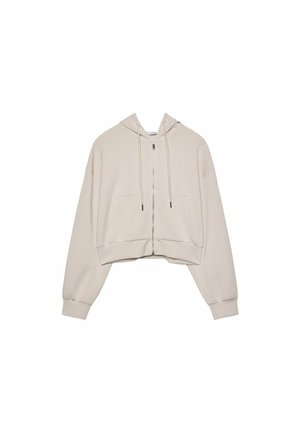 Beige verkürzter Hoodie mit Reißverschluss vorne, Kordelzügen und zwei großen Fronttaschen. Er hat lange, lässige Ärmel und gerippte Bündchen.
