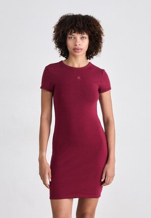 Burgundy fitted dress with short sleeves, round neck, and subtle logo accent. Made from soft, stretchy fabric for comfort.