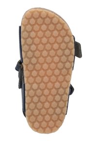 Schoenzool met een gestructureerd honingraatpatroon, in lichtbruine rubber, met een gebogen rand en een blauwe stoffen bovenkant met gespen.