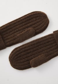 Pair of brown ribbed knit wool mittens on a white surface, showing thumb detail and soft texture.